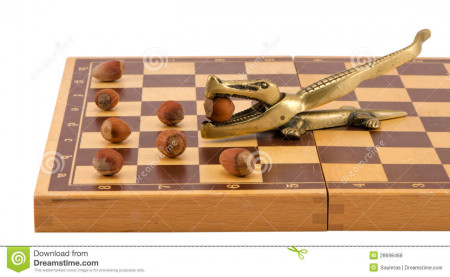 gold-crocodile-nut-crush-tool-chess-board-isolated-28698468.jpg